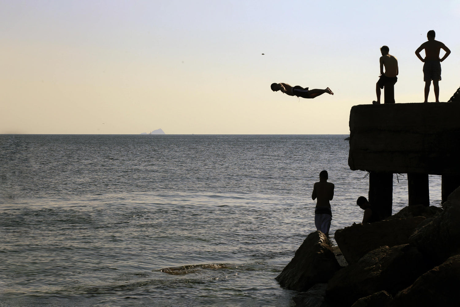 People standing on a dock near open water – embracing the joy of aquatic adventures with AQTIVAQUA swim gear